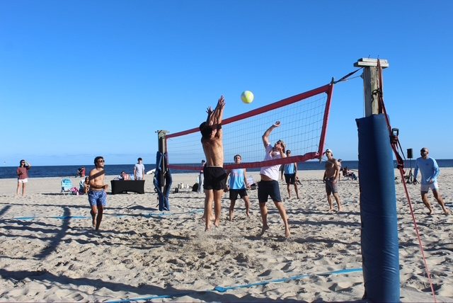 A player goes up at the net at the Summer Send-Off Volleyball Tournament